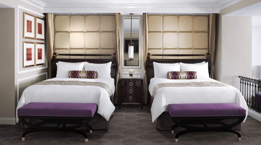Two queen beds side by side in a hotel room