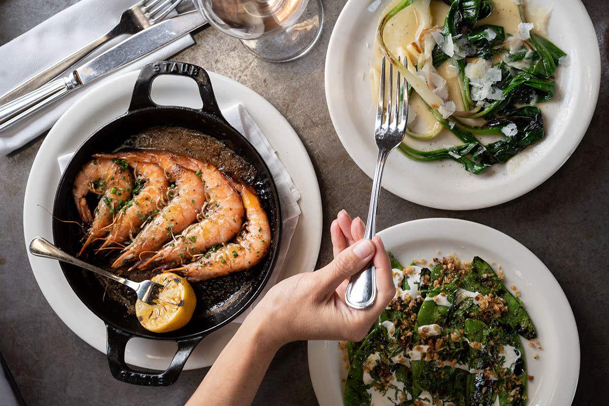 Prawns in a cast iron pan and a side of salad.
