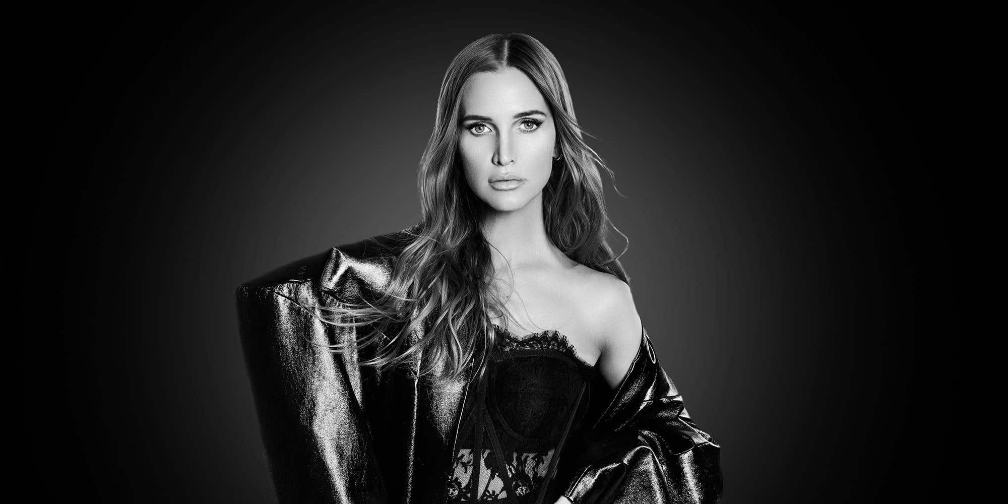 Black & white photo of singer Ashlee Simpson in a shiny jacket.