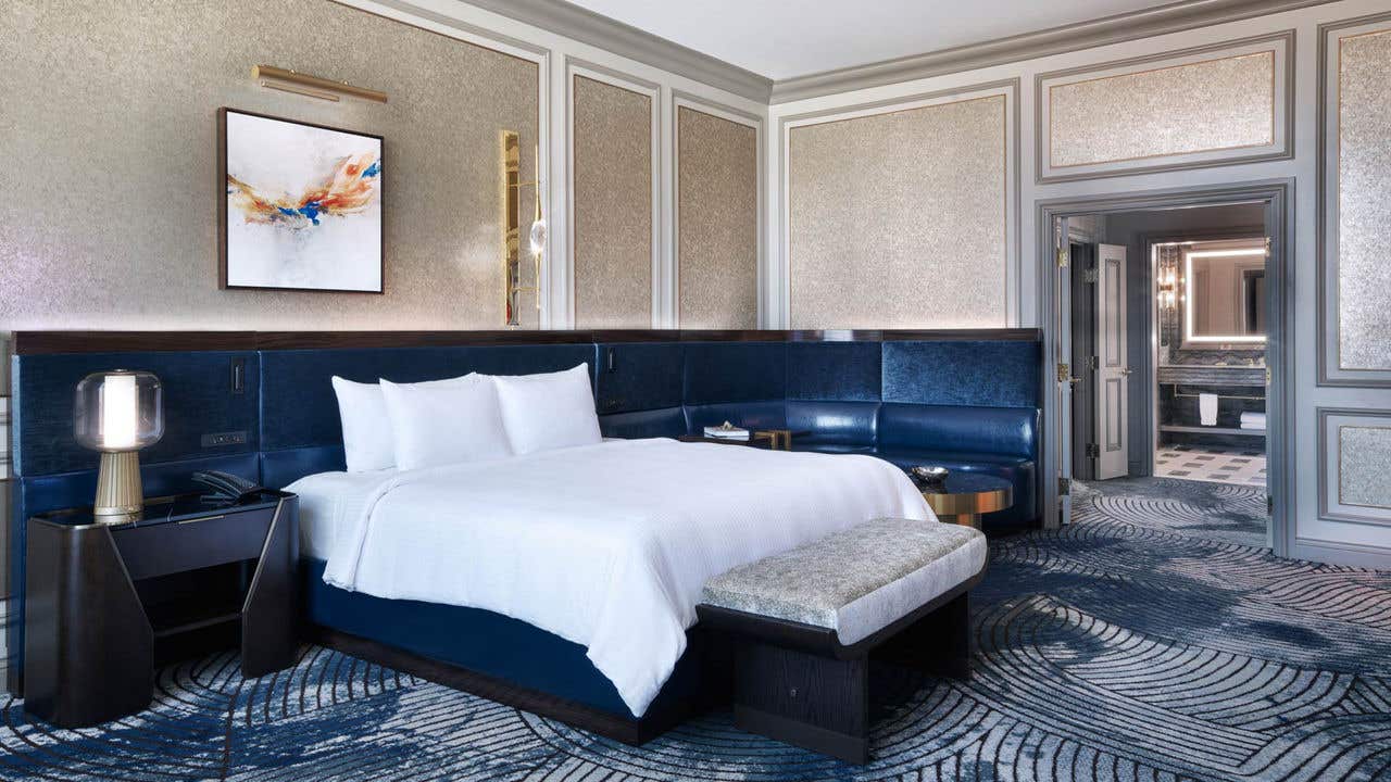 A hotel bedroom with a king bed and en suite bathroom.