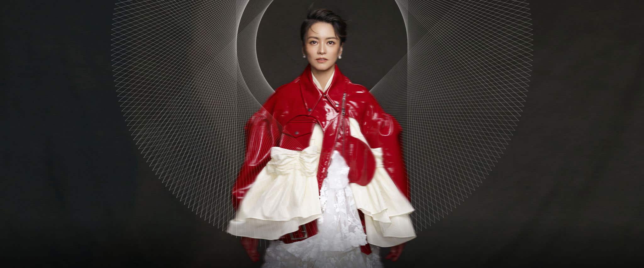 Gigi Leung in a shiny red jacket with a layered white dress, set against a dark background with intricate spiraling lines.